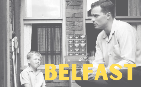 Belfast man and boy sit outside of brick building in black and white photo